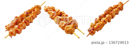 Grilled chicken Satay skewer with a golden brown glaze, isolated on white background, concept of tasty street food 136729013