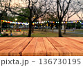Empty wooden tabletop with blurred outdoor park and colorful festival fairy lights background 136730195