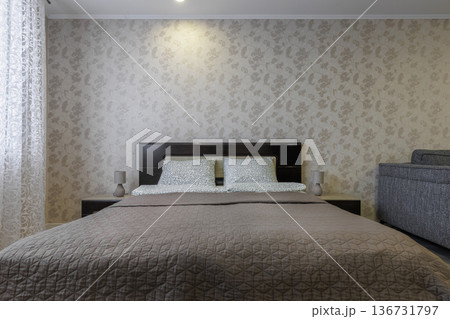 Modern Studio Apartment Interior with Bed and Floral Wallpaper Modern Studio Apartment Interior with Bed and Floral Wallpaper 136731797