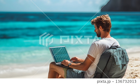 Freelancer working on a beach with a foldable solar powered laptop and turquoise water background Freelancer working on a beach with a foldable solar powered laptop and turquoise water background 136732013