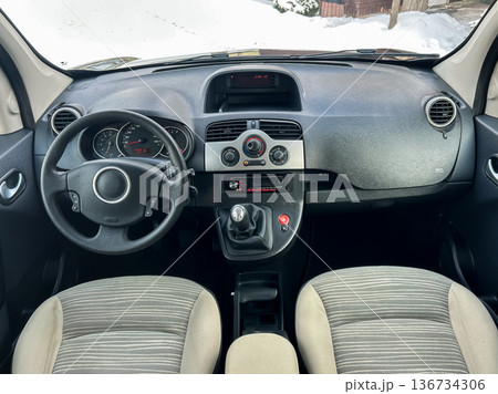 Interior view of a car dashboard with a steering wheel, gear shifter, and air conditioning controls during winter season Interior view of a car dashboard with a steering wheel, gear shifter, and air conditioning controls during winter season 136734306