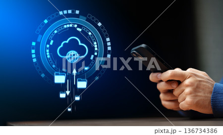 Person uses smartphone to access cloud services for data management Person uses smartphone to access cloud services for data management 136734386