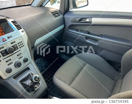 Interior of a car showing the dashboard and driver's seat during winter season 136734395