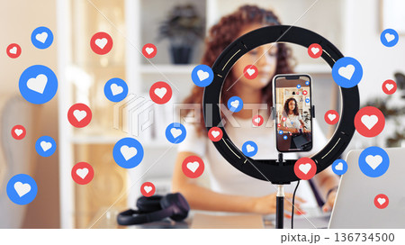 Podcaster filming episode with social media reactions while working at desk in home office Podcaster filming episode with social media reactions while working at desk in home office 136734500