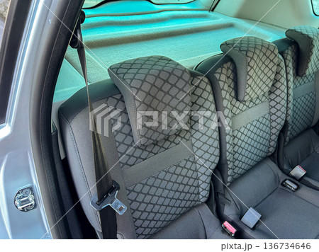 Backseat view of an SUV with black fabric seats and headrests during daylight hours 136734646