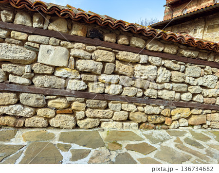 Old stone wall with wooden beams under blue sky in historical location during daytime Old stone wall with wooden beams under blue sky in historical location during daytime 136734682