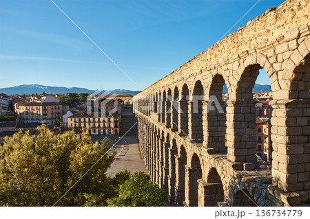 Majestic arches of Segovia aqueduct under a clear blue sky Majestic arches of Segovia aqueduct under a clear blue sky 136734779