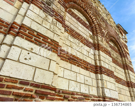 Building wall with red bricks and white stones at a historical location in bright daylight 136734865