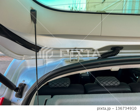 Car trunk with open lid shows storage space and interior view at a parking area on a sunny day Car trunk with open lid shows storage space and interior view at a parking area on a sunny day 136734910