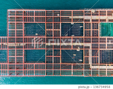 View of a large wooden structure built over water with open spaces during daylight hours in a coastal area View of a large wooden structure built over water with open spaces during daylight hours in a coastal area 136734958