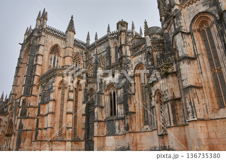 Batalha Monastery with Gothic facades and detailed sculptures in the foreground in a historic setting and heritage restoration 136735380
