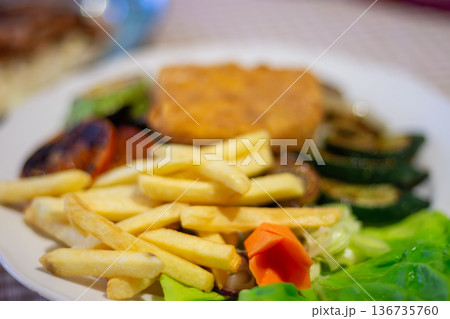 Fried fish fillet with french fries and salad on plate 136735760