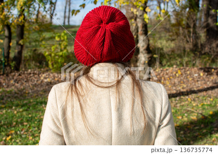 Woman in Red Beanie in Autumn Park, Rear View Woman in Red Beanie in Autumn Park, Rear View 136735774