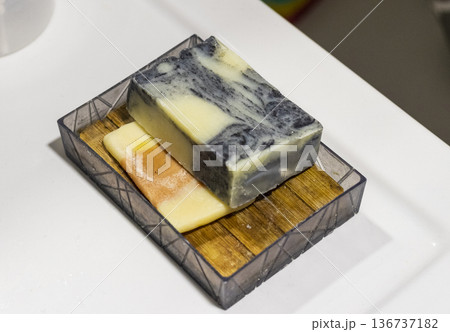 The soap bar holder with handmade bar soap containing activated charcoal, neem oil, hemp oil, and shea butter. 136737182