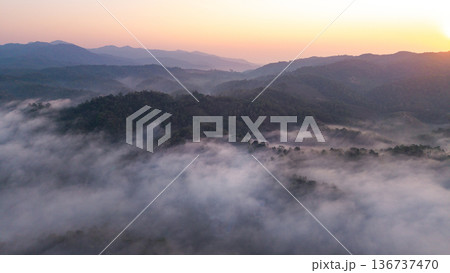 Majestic mountain landscape with morning fog and golden sunrise light. Majestic mountain landscape with morning fog and golden sunrise light. 136737470