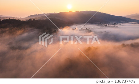 Aerial view of beautiful sunrise over the sea of mist in the mountains. Aerial view of beautiful sunrise over the sea of mist in the mountains. 136737478