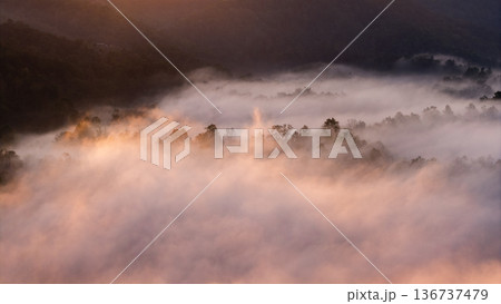 Aerial view of beautiful sunrise over the sea of mist in the mountains. Aerial view of beautiful sunrise over the sea of mist in the mountains. 136737479