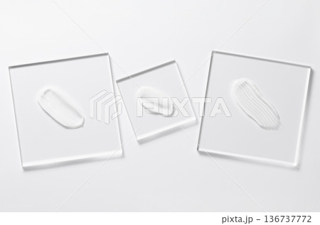 White cosmetic skin care product on glass. White background. White cosmetic skin care product on glass. White background. 136737772