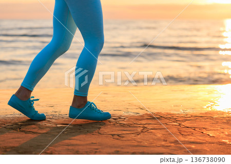 Sporty young woman is running against sea background during her vacation. Freedom and summer sport concept 136738090