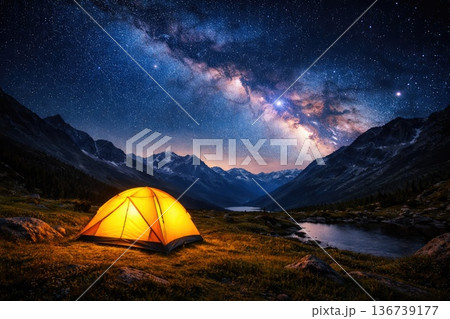 Glowing camping tent under starry Milky Way sky in mountain landscape at night Glowing camping tent under starry Milky Way sky in mountain landscape at night 136739177