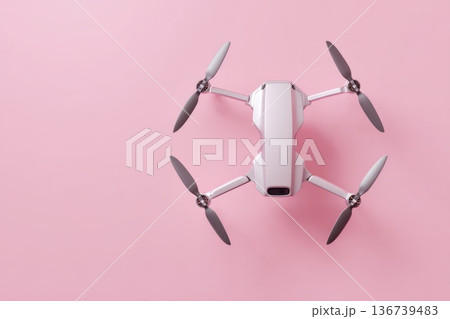 Compact drone top view isolated on pink background modern technology gadget Compact drone top view isolated on pink background modern technology gadget 136739483