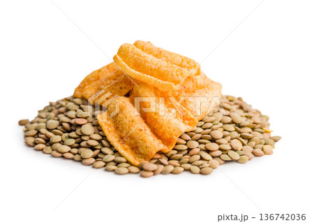 Crispy lentil chips isolated on white background. Crispy lentil chips isolated on white background. 136742036