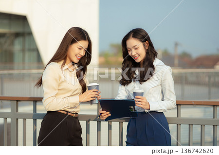 Business team walking and talking on street in city Outside Office and drinking coffee together, partners, teamwork. Business team walking and talking on street in city Outside Office and drinking coffee together, partners, teamwork. 136742620