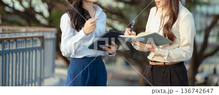 Business team talking outside office, with discussing update tasks with milestones progress planning and professional investor working new start up project. Business team talking outside office, with discussing update tasks with milestones progress planning and professional investor working new start up project. 136742647