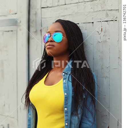 Fashionable young African woman in casual clothing, stylish modern black girl posing in the city 136742701