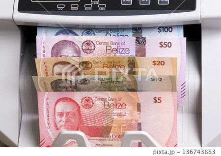 Belizean Dollars in the counting machine 136743883