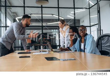 In conference room by the table. Business people are working in the office In conference room by the table. Business people are working in the office 136744545