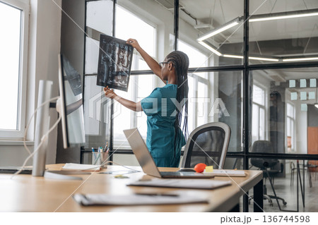 Female doctor in coat is in the office clinic 136744598