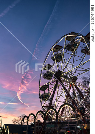Ferris Wheel Silhouette Against Pink Sunset Sky 136744991