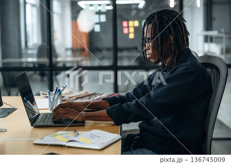 Modern technology, laptop and display are on the table. Designer is working in the office 136745009