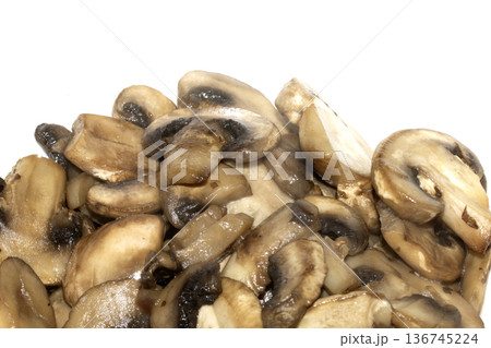 Close up of fried chopped sliced mushrooms on white background Close up of fried chopped sliced mushrooms on white background 136745224