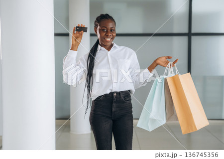 Credit card in hand, payment, shopping. Businesswoman in formal clothes is in the modern room 136745356