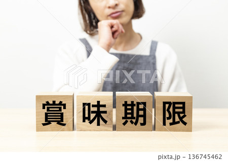 「賞味期限」と書かれたブロックとエプロン姿の女性 136745462