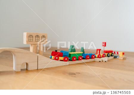 Wooden railway toy set displayed in modern apartment interior. Clean product-style image suitable for catalog, online shop or advertising campaign. Wooden railway toy set displayed in modern apartment interior. Clean product-style image suitable for catalog, online shop or advertising campaign. 136745503
