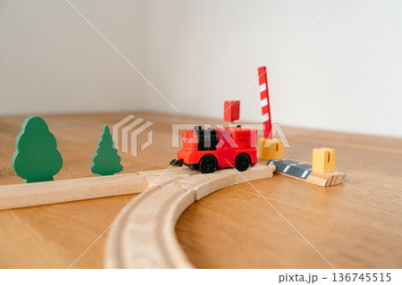 Colorful wooden train on curved railway track in minimalist interior. Educational toy for preschool children, creative play and early development concept. Colorful wooden train on curved railway track in minimalist interior. Educational toy for preschool children, creative play and early development concept. 136745515