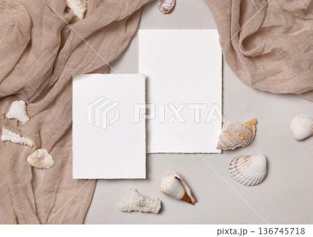 Blank paper cards mockup with seashells on beige stone, coastal wedding stationery, copy space Blank paper cards mockup with seashells on beige stone, coastal wedding stationery, copy space 136745718