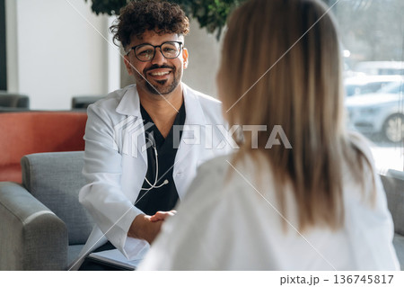 Consultation with doctor. Man and woman are indoors in modern building 136745817