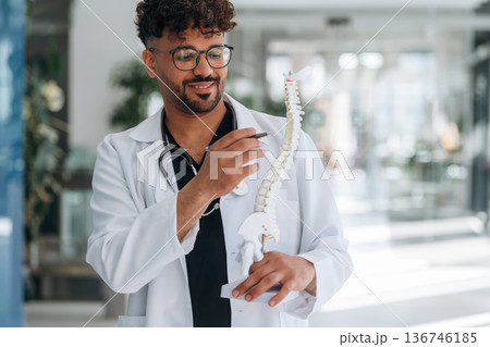 Front view. Doctor is indoors in the modern building Front view. Doctor is indoors in the modern building 136746185
