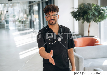 Standing and posing. Doctor is indoors in the modern building 136746218