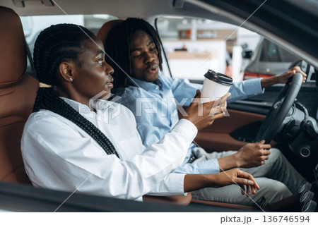 Sweet couple. Man and woman are in the automobile Sweet couple. Man and woman are in the automobile 136746594