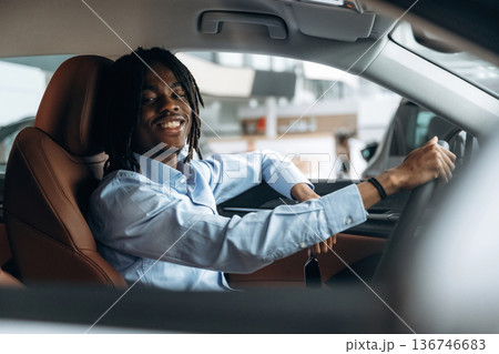 Man in shirt is in the modern car Man in shirt is in the modern car 136746683