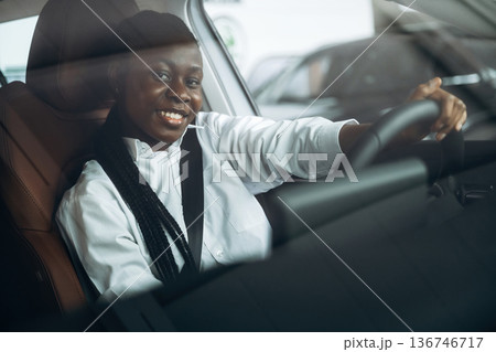 Woman in white shirt is in the modern car Woman in white shirt is in the modern car 136746717