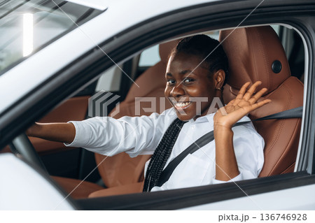 Woman in white shirt is in the modern car 136746928