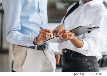 Man with woman are making business, signing documents, close up view Man with woman are making business, signing documents, close up view 136747018