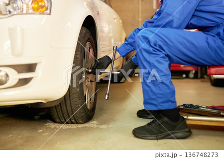 工場でタイヤ交換をする自動車整備士 工場でタイヤ交換をする自動車整備士 136748273