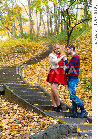 Romantic pair meet in park standing on stairs. Romantic pair meet in park standing on stairs. 136748391